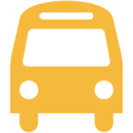 A simple, yellow icon of a bus seen from the front, featuring a windshield, two headlights, and rounded edges on a white background.