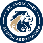 Circular logo for St. Croix Prep Alumni Association, featuring a stylized blue and gold lion head in the center, with the organization’s name in white text on a dark blue border.